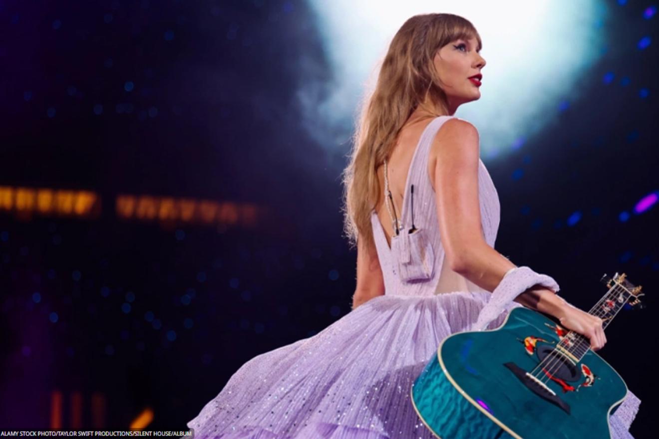 American singer-songwriter Taylor Swift holding a guitar during one of her concerts.