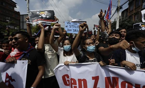 Young protesters march through Kathmandu on Monday, holding signs denouncing corruption and nepotism. The protest was met with a violent crackdown that left at least 19 people dead.