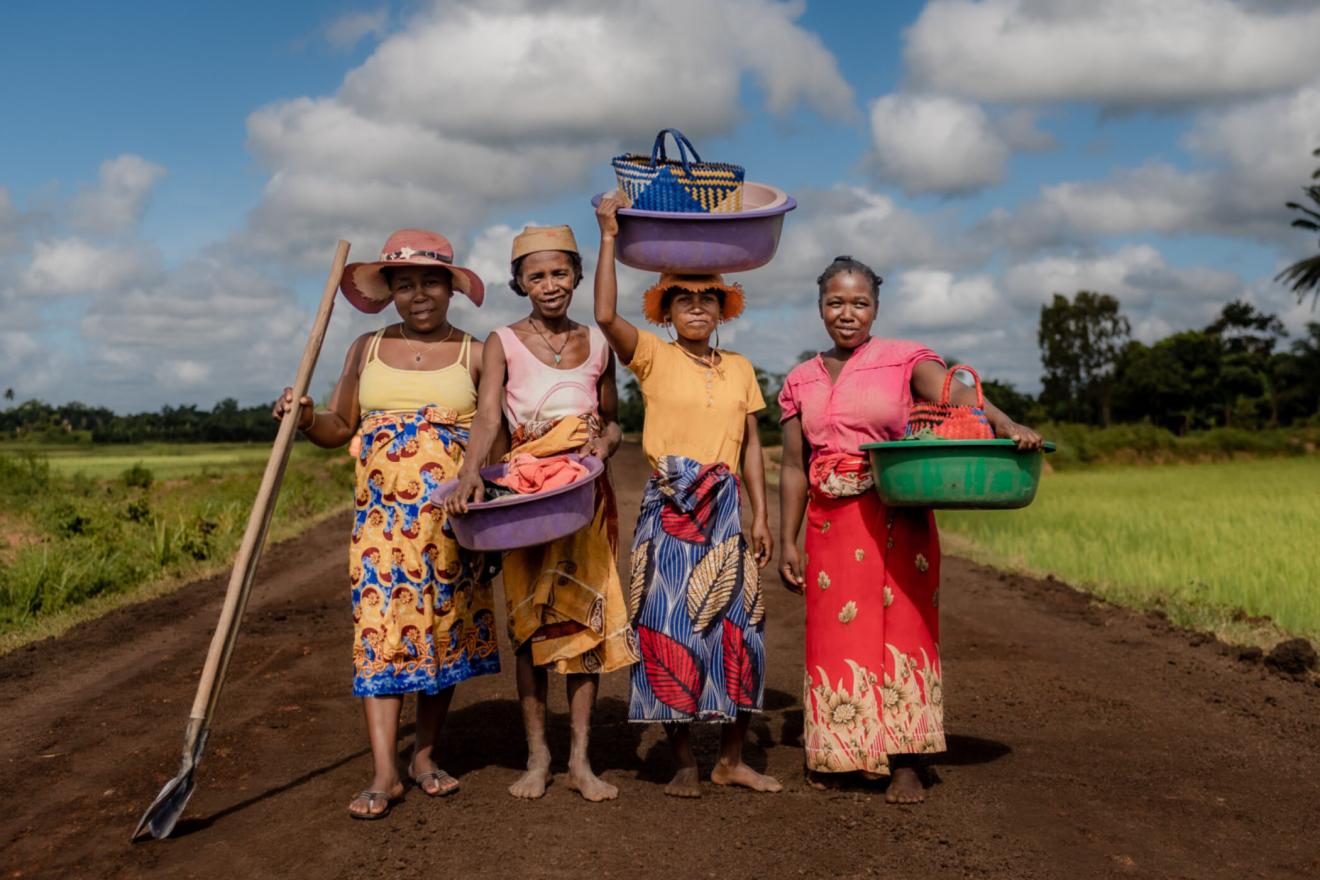 smiling female agricultural workers on a road