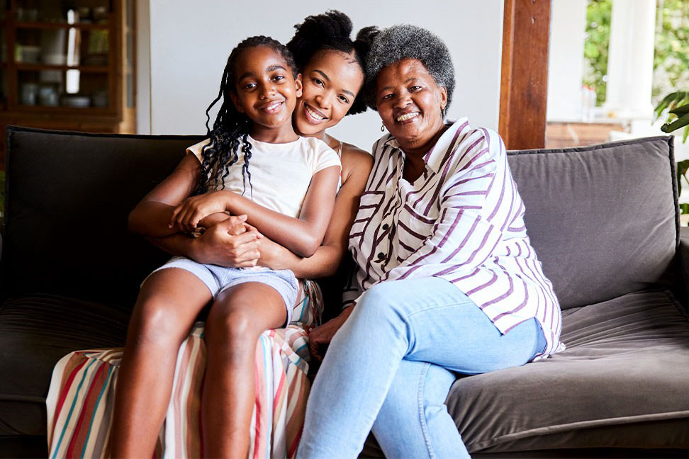 A group of three generations, girl, mother and grandmother of African descent. 