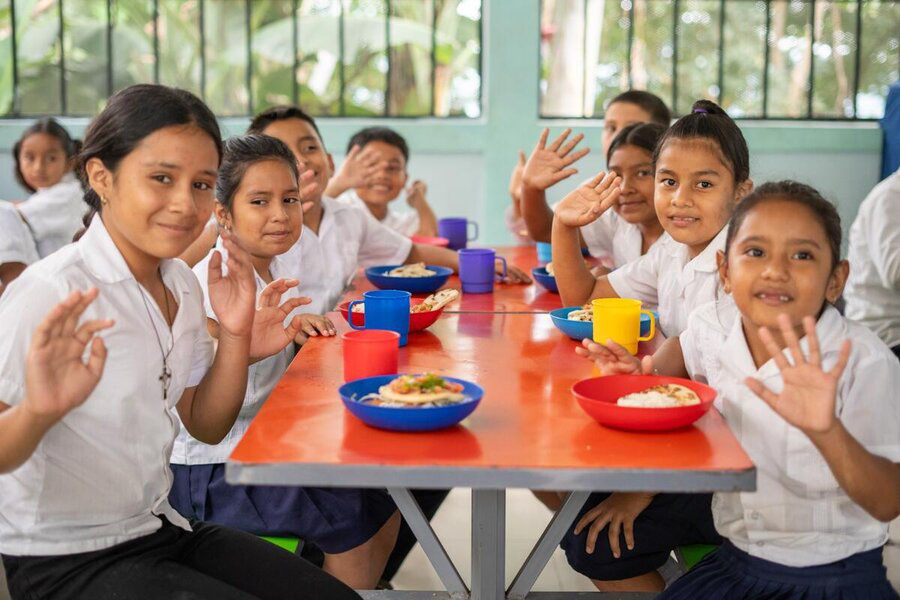 A group of students at school lunch hall having a meal.