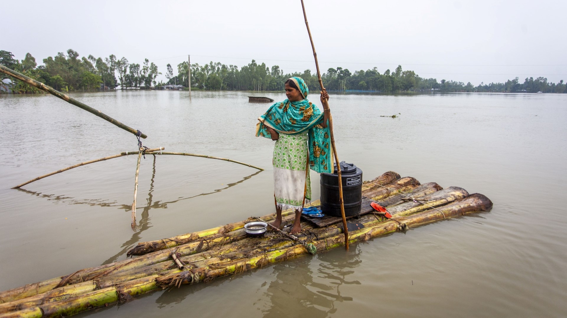 woman on raft in flooded area