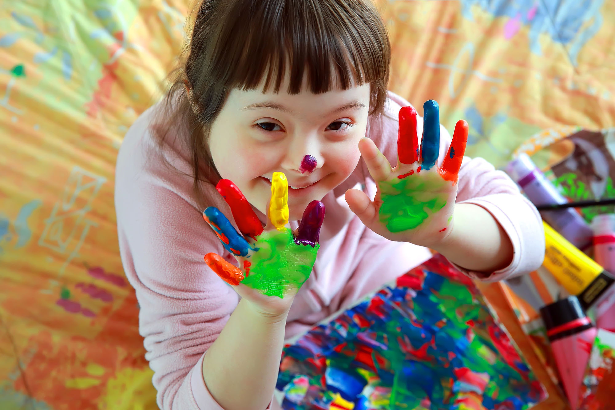 Cute little girl with painted hands 