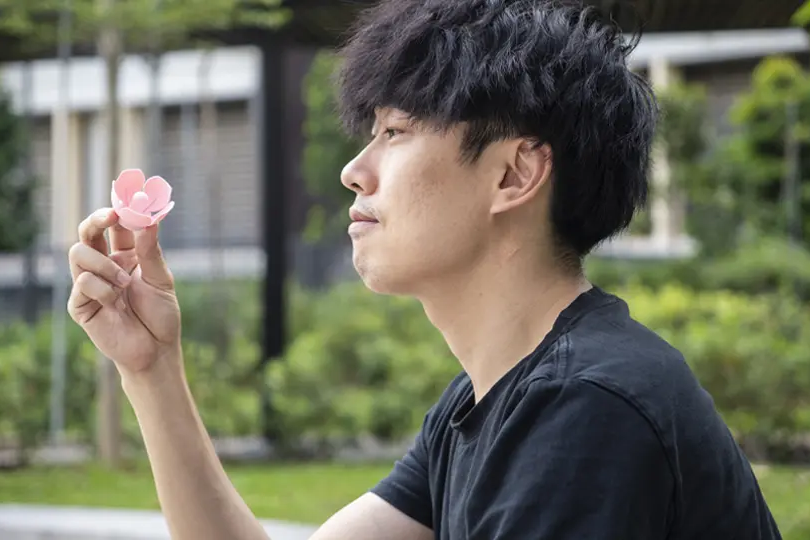 Matt Chiu, holding his new invention, Hanabii pacifier.